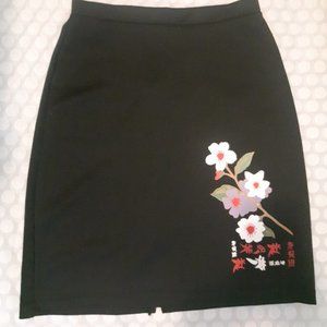 Small above knee fitted black skirt